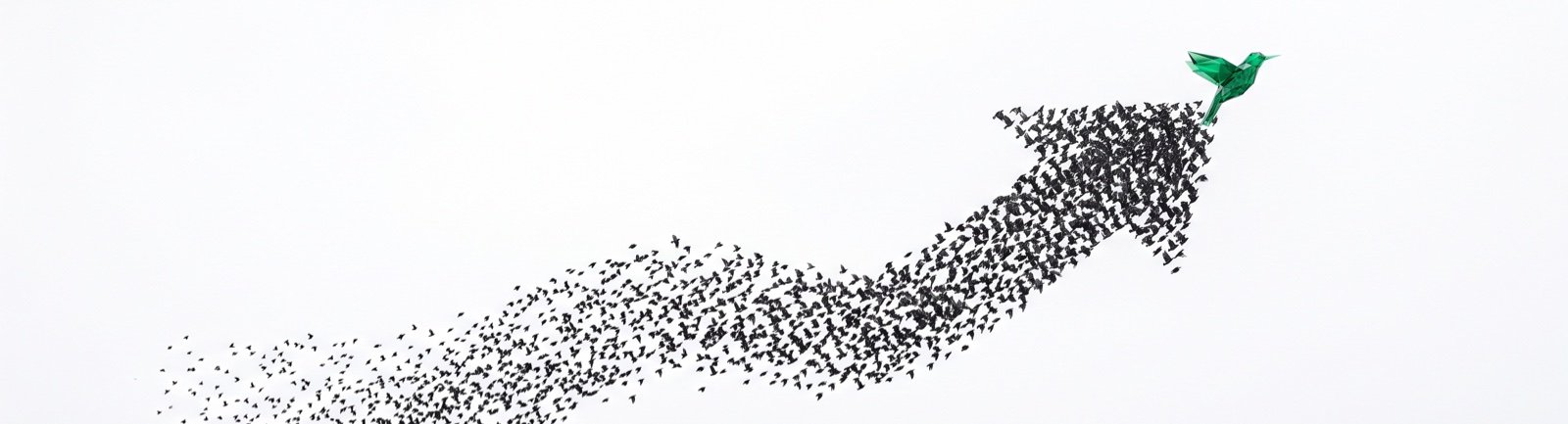 A murmuration of starlings forming a rising arrow, led by a single emerald bird